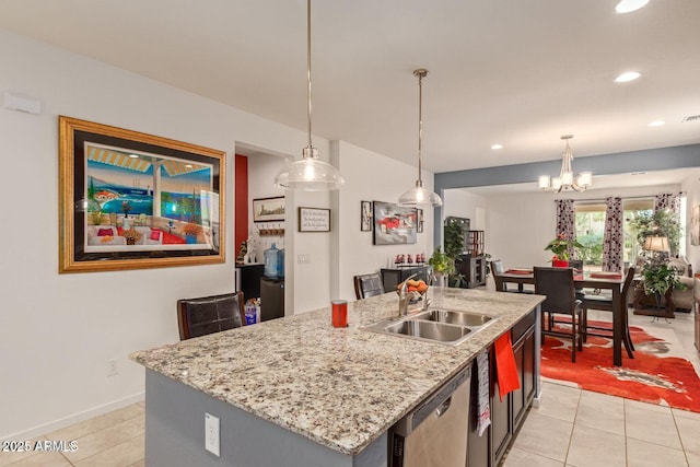 kitchen featuring pendant lighting, a sink, dishwasher, and light tile patterned floors