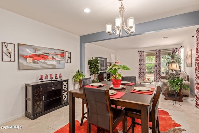 dining space with a notable chandelier, baseboards, and light tile patterned floors