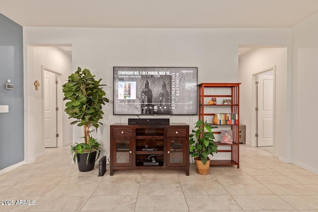 living area featuring tile patterned flooring and baseboards