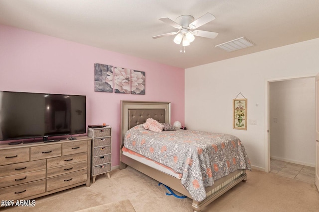 bedroom with visible vents, baseboards, a ceiling fan, and light colored carpet