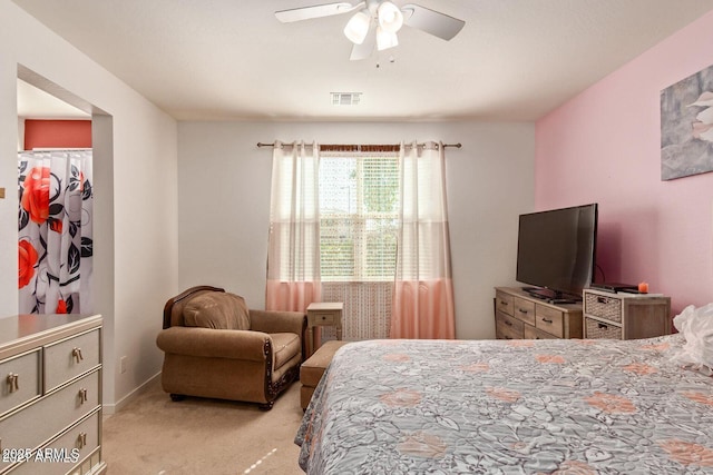 bedroom with visible vents, ceiling fan, and light carpet