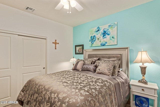 bedroom with a closet, visible vents, and ceiling fan