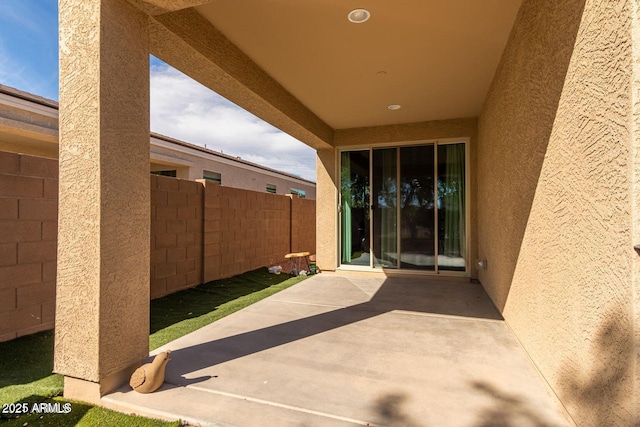 view of patio / terrace featuring fence