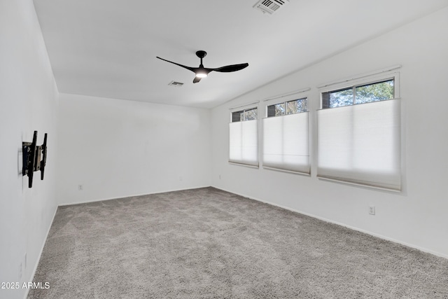 unfurnished room with ceiling fan, carpet floors, and lofted ceiling