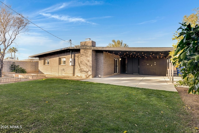 view of front of house with a front yard and a carport