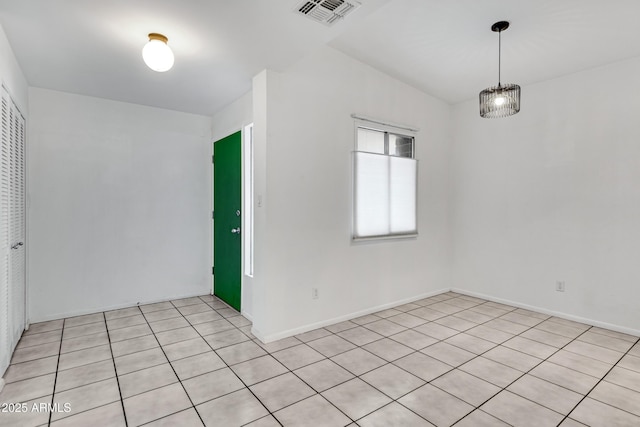 unfurnished room featuring light tile patterned floors