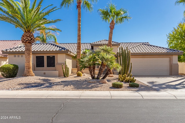 mediterranean / spanish-style home featuring a garage