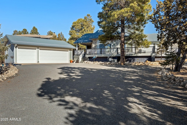 view of front facade with a garage and a deck