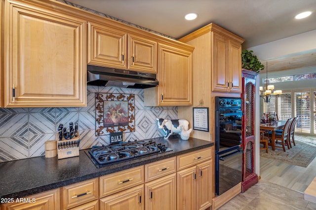 kitchen featuring light hardwood / wood-style flooring, stainless steel gas stovetop, hanging light fixtures, an inviting chandelier, and decorative backsplash