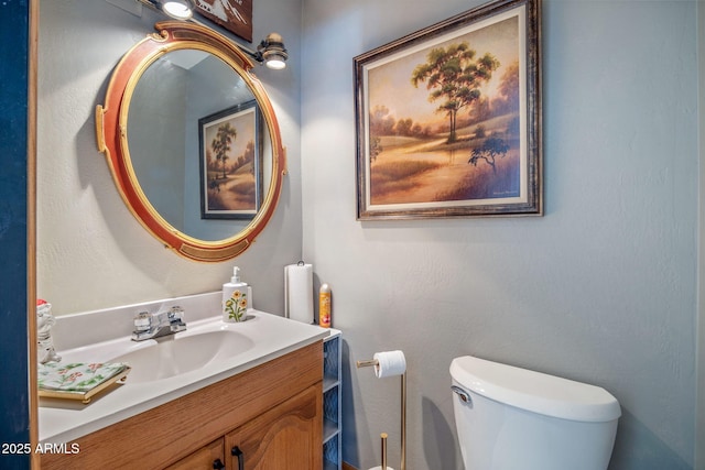 bathroom with toilet and vanity