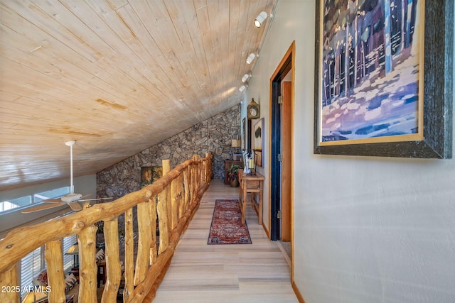 hallway featuring light hardwood / wood-style flooring, vaulted ceiling, and wood ceiling