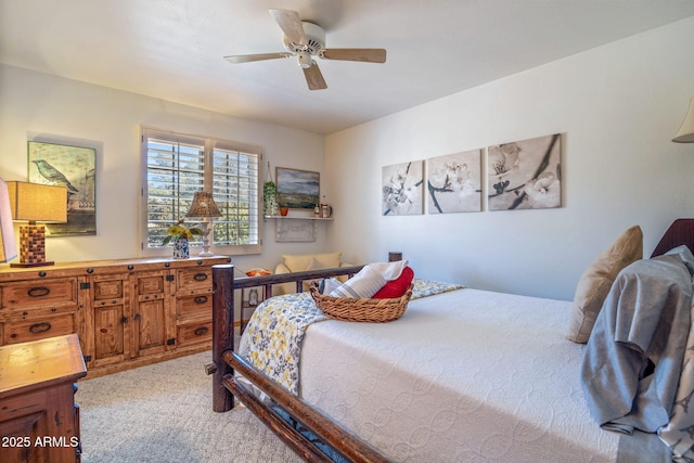 bedroom featuring light colored carpet and ceiling fan