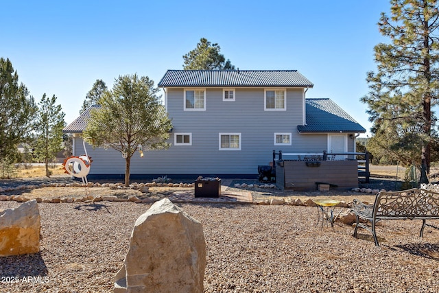 rear view of house with a jacuzzi