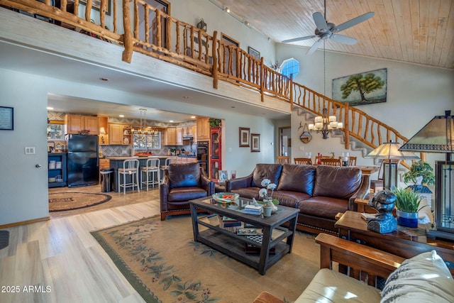 living room with ceiling fan with notable chandelier, high vaulted ceiling, light hardwood / wood-style flooring, and wooden ceiling