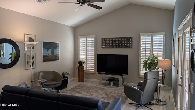 living room featuring wood finished floors, a healthy amount of sunlight, ceiling fan, and vaulted ceiling