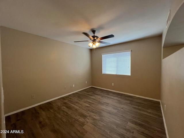 unfurnished room featuring ceiling fan and dark wood-type flooring