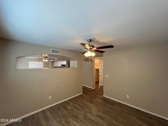 spare room with ceiling fan and dark hardwood / wood-style floors