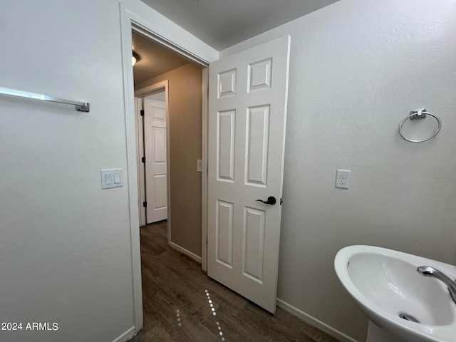 bathroom with hardwood / wood-style flooring and sink