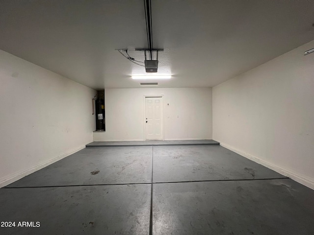 garage featuring water heater and a garage door opener