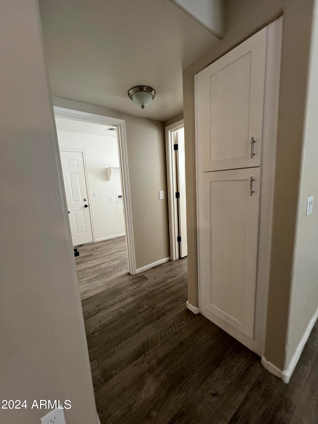 hall with dark hardwood / wood-style flooring