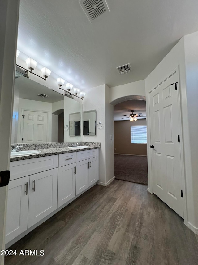 bathroom with ceiling fan, vanity, and hardwood / wood-style flooring