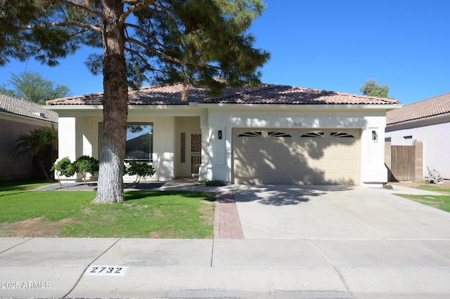 view of front of property with a garage and a front lawn