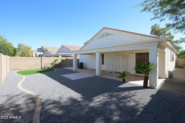 rear view of property with a patio and central air condition unit