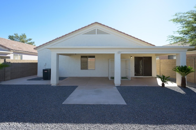 rear view of property with a patio and cooling unit