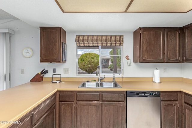 kitchen featuring a sink, stainless steel dishwasher, dark brown cabinets, and light countertops