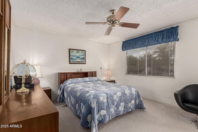 carpeted bedroom with a textured ceiling and a ceiling fan