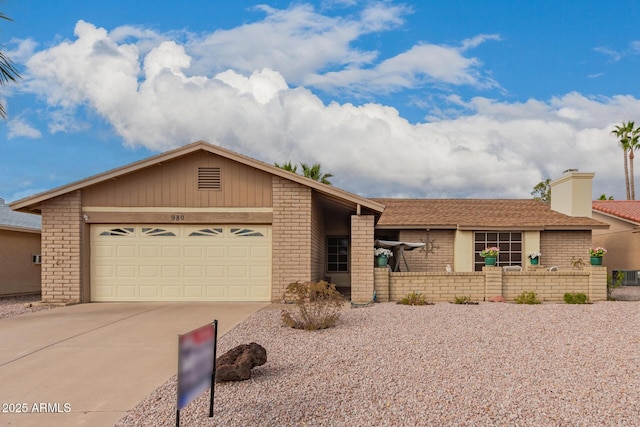 view of front facade with concrete driveway, an attached garage, and brick siding