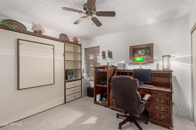 office space with light carpet, a textured ceiling, and ceiling fan