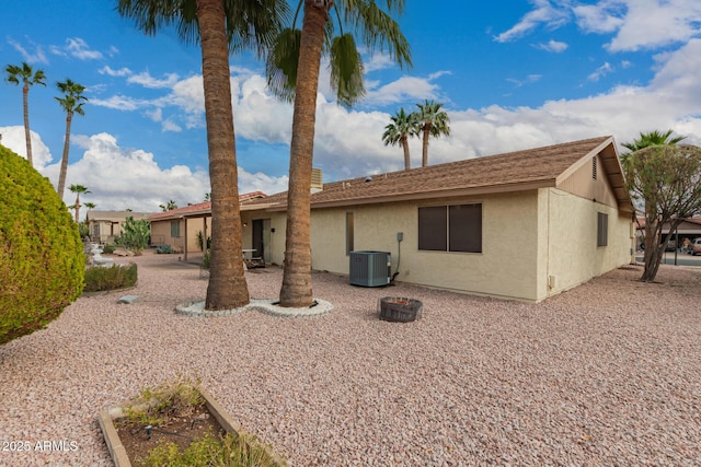 back of house with cooling unit, a patio area, and stucco siding