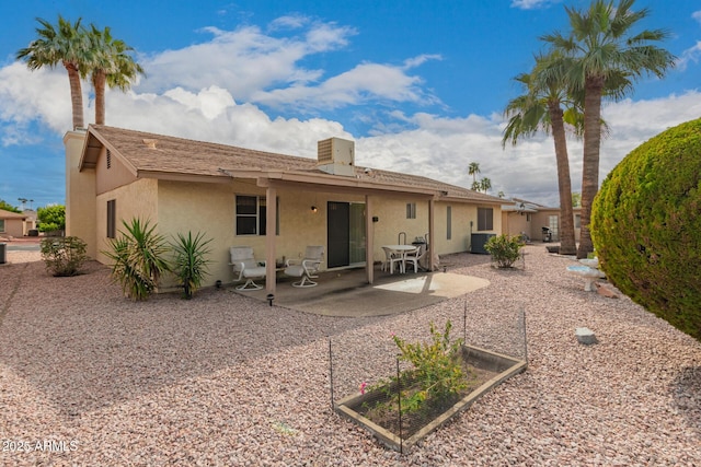 back of house featuring stucco siding, central AC, and a patio area