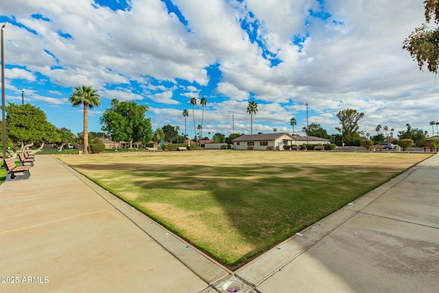 view of home's community with a yard