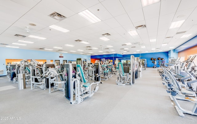 gym with a drop ceiling and visible vents