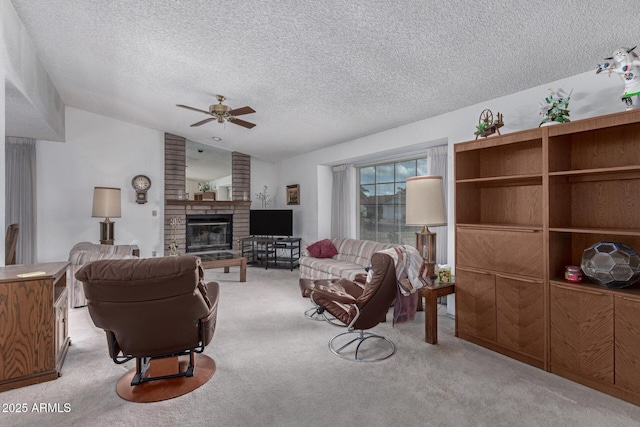 living area featuring ceiling fan, vaulted ceiling, carpet floors, a fireplace, and a textured ceiling