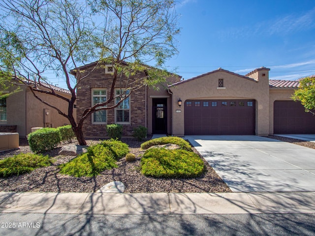16881 W Merrell St, Goodyear, AZ 85395 - view of front of house featuring a garage, driveway, stucco siding, and a tile roof
