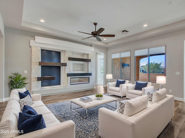 16881 W Merrell St, Goodyear, AZ 85395 - living area with baseboards, a tray ceiling, wood finished floors, ceiling fan, and recessed lighting