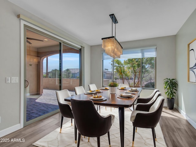 16881 W Merrell St, Goodyear, AZ 85395 - dining room featuring light wood-style flooring, baseboards, and a chandelier