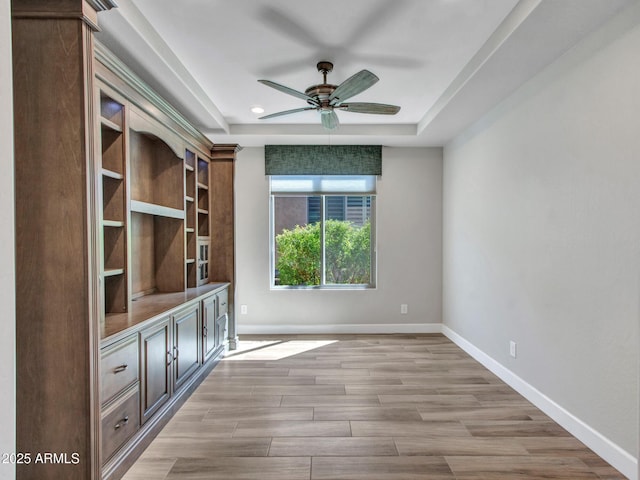16881 W Merrell St, Goodyear, AZ 85395 - unfurnished living room with a ceiling fan, a raised ceiling, baseboards, light wood-style floors, and recessed lighting