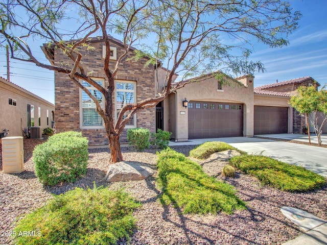 16881 W Merrell St, Goodyear, AZ 85395 - view of front of property with a garage, driveway, central AC, and stucco siding