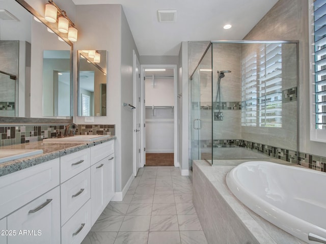 16881 W Merrell St, Goodyear, AZ 85395 - full bathroom with a garden tub, a stall shower, double vanity, marble finish flooring, and healthy amount of natural light