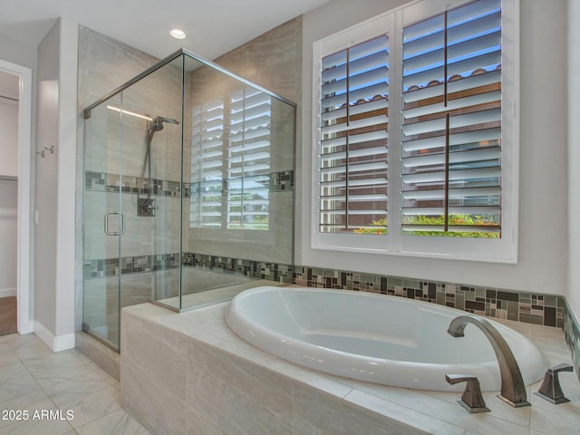 16881 W Merrell St, Goodyear, AZ 85395 - bathroom featuring a bath, a stall shower, plenty of natural light, baseboards, and recessed lighting