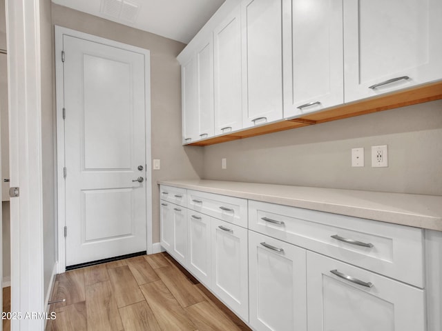16881 W Merrell St, Goodyear, AZ 85395 - laundry area with light wood-style floors and baseboards