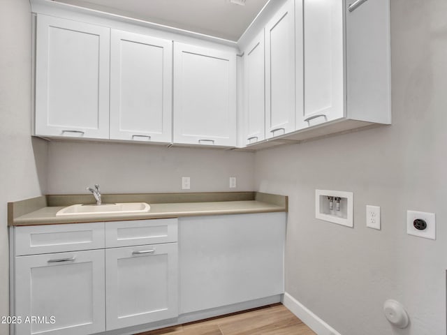 16881 W Merrell St, Goodyear, AZ 85395 - laundry area featuring hookup for an electric dryer, washer hookup, cabinet space, baseboards, and light wood-style flooring