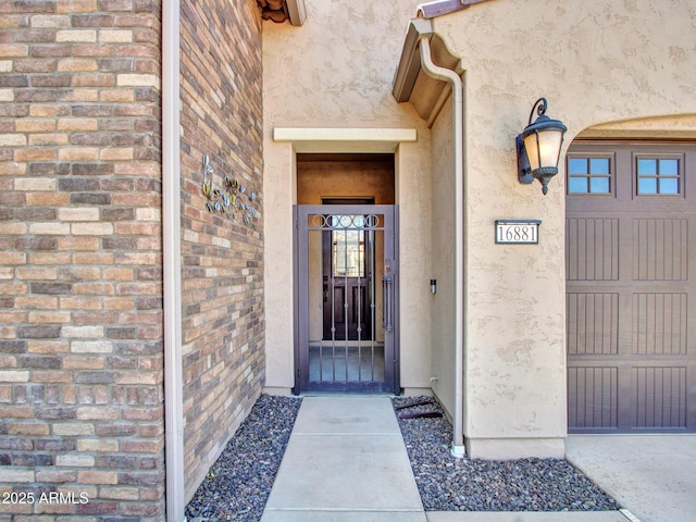 16881 W Merrell St, Goodyear, AZ 85395 - doorway to property featuring stucco siding, a gate, and brick siding