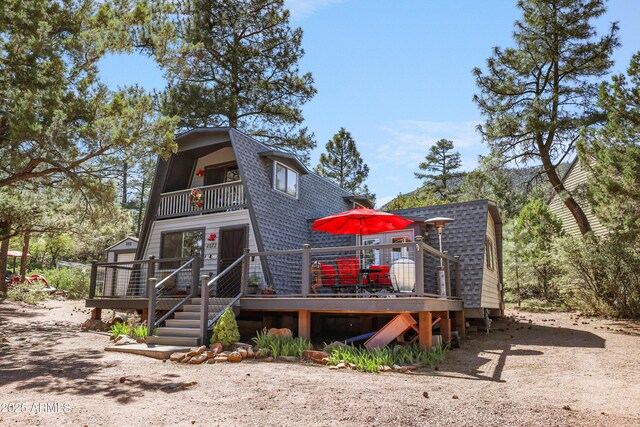 4872 N Trails End Dr, Pine, AZ 85544 - a-frame style home featuring a gambrel roof, a balcony, roof with shingles, and a deck