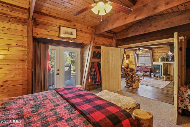 4872 N Trails End Dr, Pine, AZ 85544 - carpeted bedroom featuring wooden walls, multiple windows, access to outside, wooden ceiling, and a fireplace