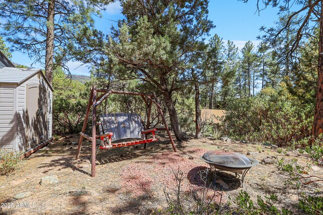 4872 N Trails End Dr, Pine, AZ 85544 - view of yard with a storage shed, an outbuilding, and an outdoor fire pit